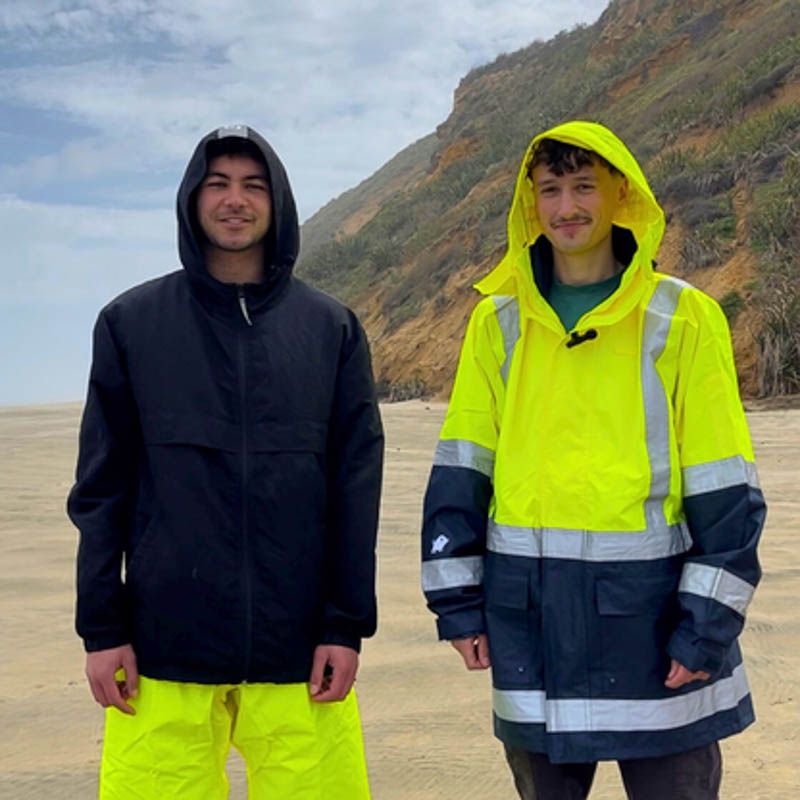 Photo of two men wearing high-vis rain gear.